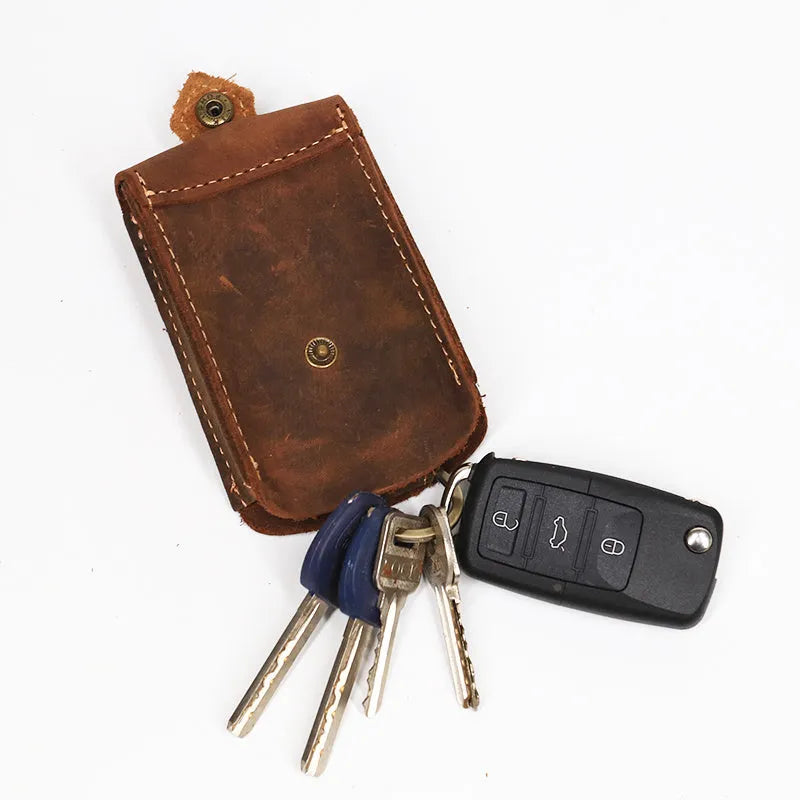 Crazy horse leather key case in dark brown, 7cm by 11.5cm, resting on a surface