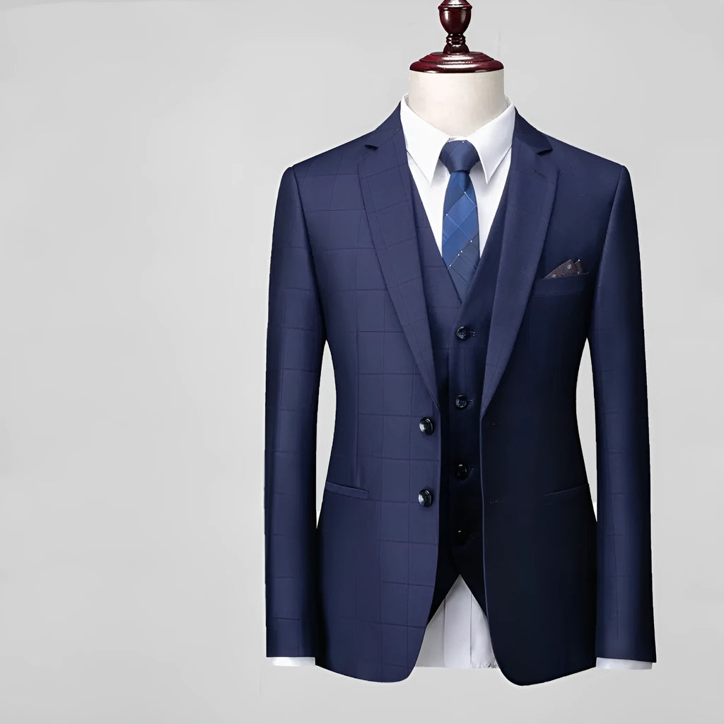 Men's navy blue plaid slim fit three-piece suit with vest, jacket, and trousers on a hanger.