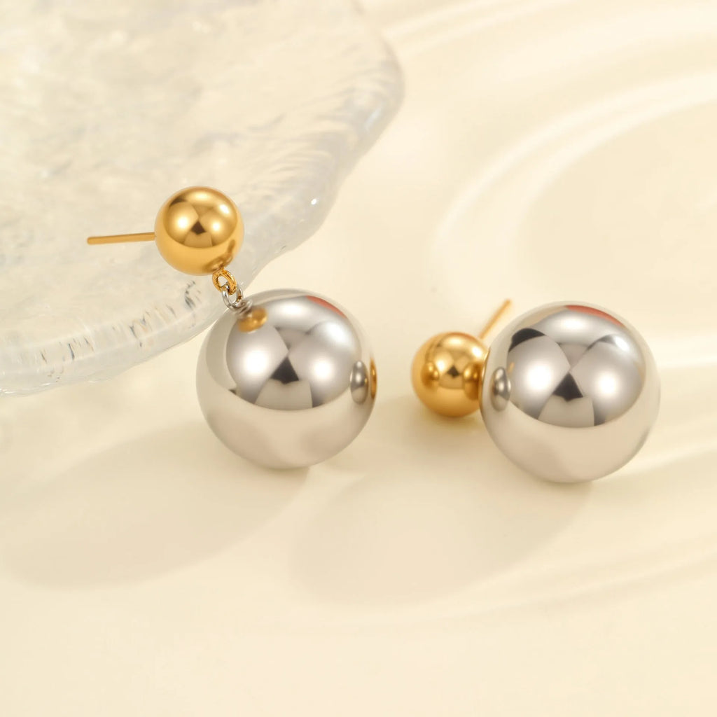 Stainless steel geometric ear studs with round beads and colour-block electroplated finish.