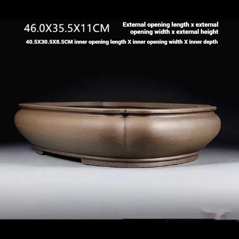 Handmade antique papaya-shaped purple clay flower pot, 46cm long, on a wooden surface.
