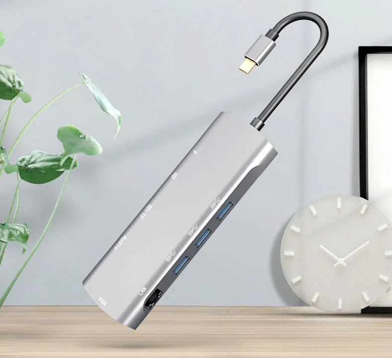 Grey aluminium USB-C docking station with HDMI, VGA, and USB ports on 140mm cable
