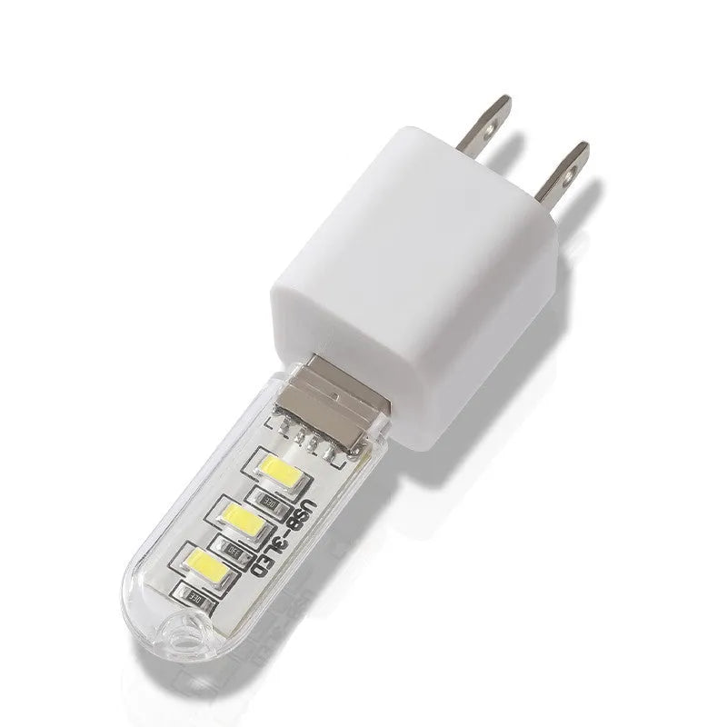 Compact white LED baby night light with USB cable showing warm and white light options