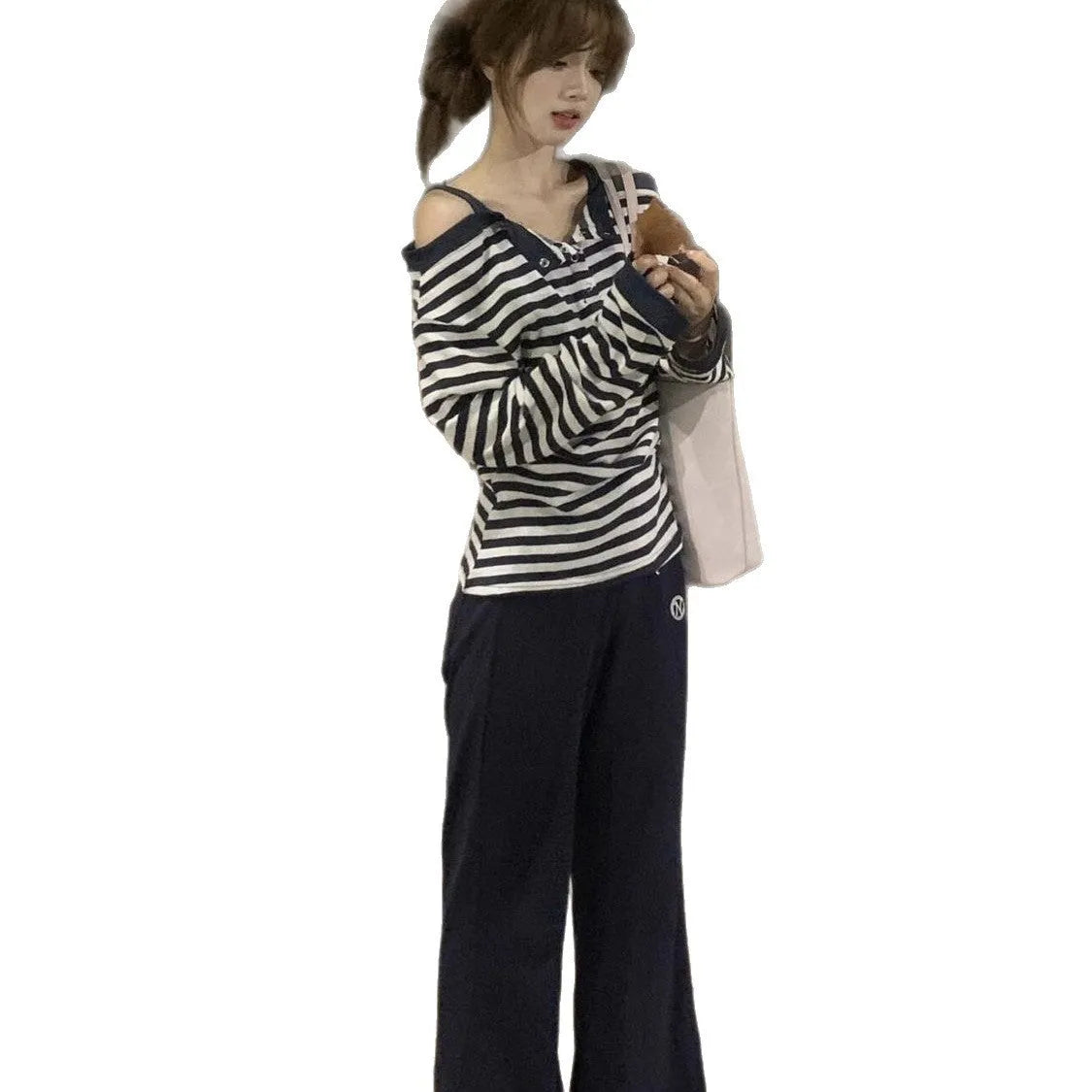 Dark blue Korean-style women's oversized long sleeve t-shirt with stripe and embroidery details on a hanger.