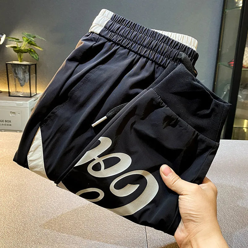 Black men's cropped casual trousers with ankle banding made from ultra-thin ice silk cotton fabric.