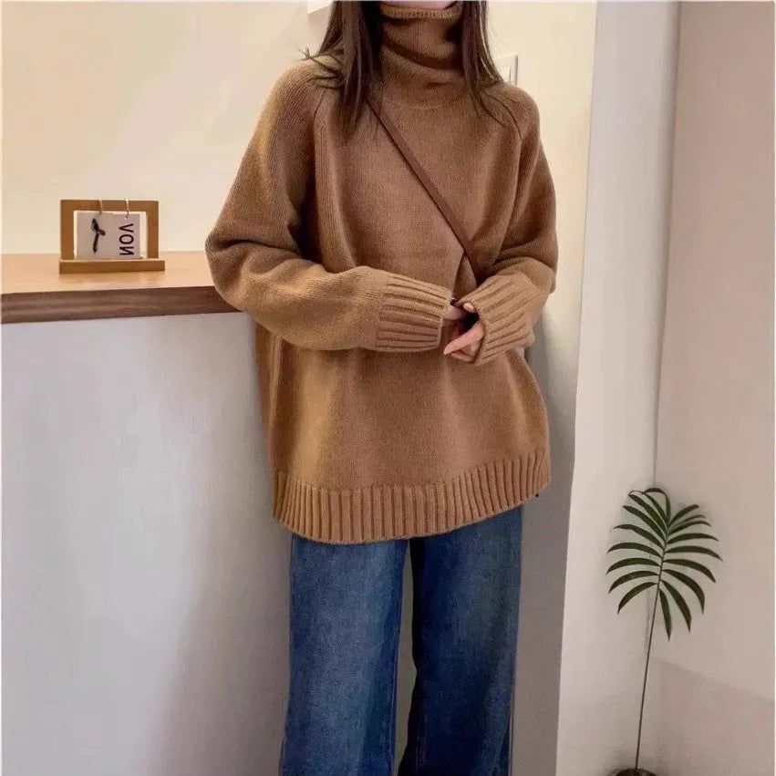 Women's loose black turtleneck sweater with a thick curling pile collar, casual style.