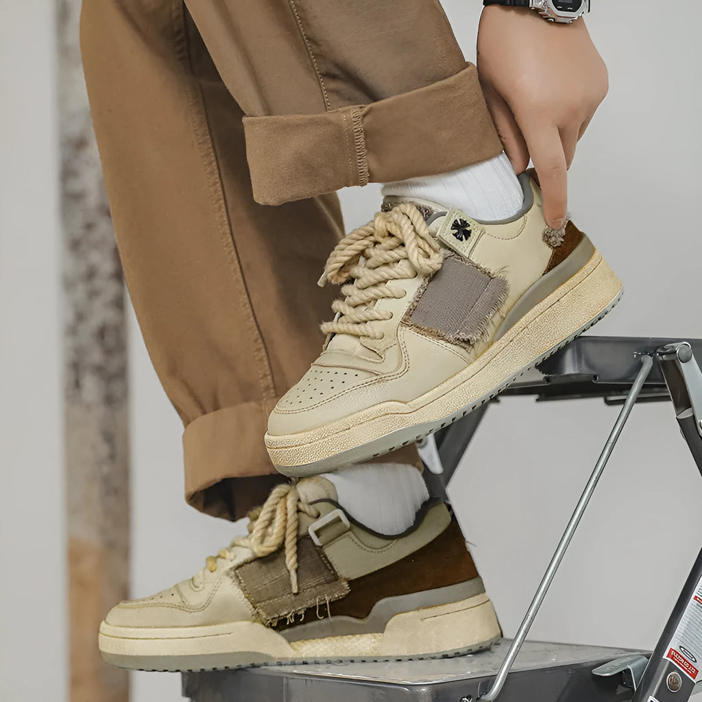 Beige vintage skateboard shoes with patch design, low-top cut, and round toe