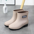 Women's mid-calf rain boots in black, PVC upper, shown with a low heel.