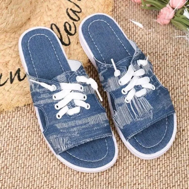 Blue Roman-style canvas slippers with flat rubber soles and cloth upper