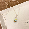 Women's coloured glaze small fish lucky bag pendant on a cotton linen clavicle chain necklace.