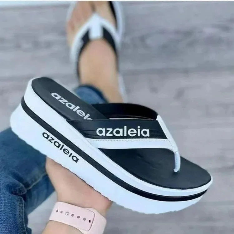 Women's black PU platform slipper with herringbone toe holder design on a solid colour background.
