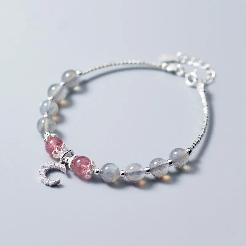 Handmade silver-tone adjustable bracelet with a moonstone bead and crescent moon charm.