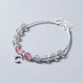 Handmade silver-tone adjustable bracelet with a moonstone bead and crescent moon charm.