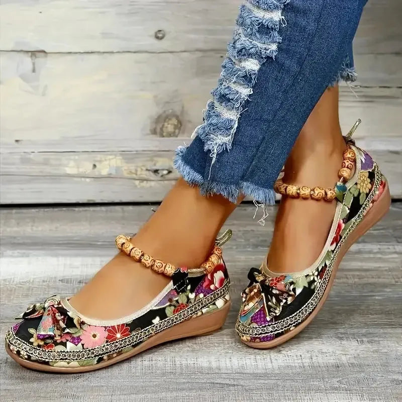 Women's black plus size ethnic platform sandals with elastic band fastening.