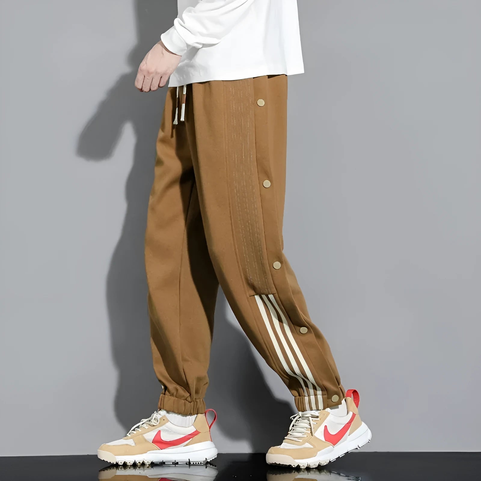 Men's black loose-fit cotton blend sweatpants with ankle ties and a drawstring waist.