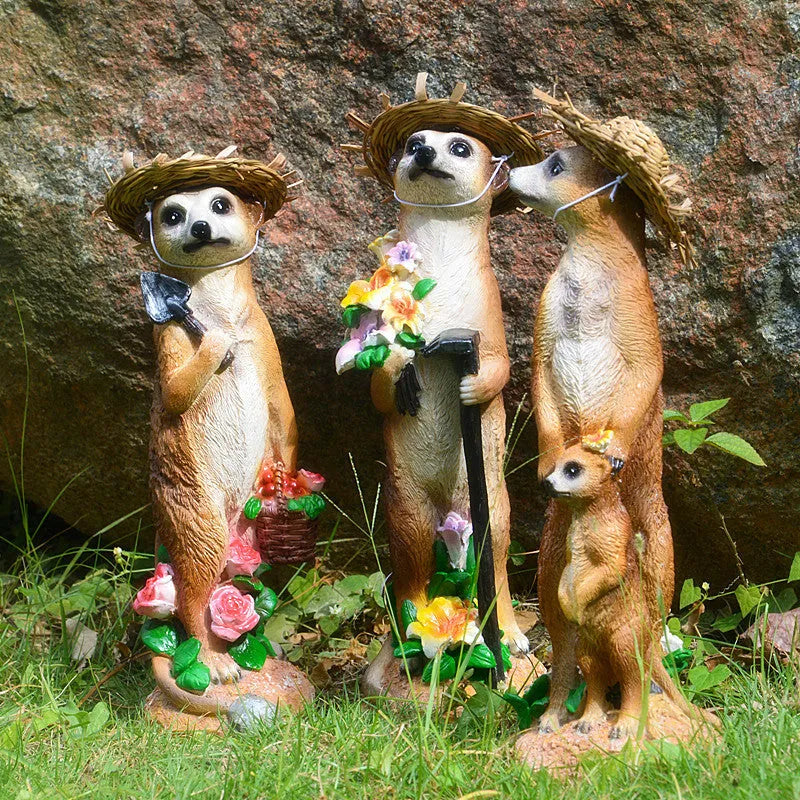 Three straw hat mongoose garden ornaments including mother and child, rake carrier, and shovel carrier designs