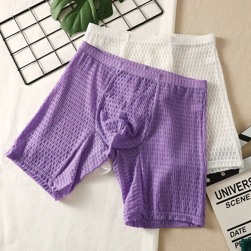 Men's lace boxer shorts in a lengthened hip lifting design, shown in one of five solid colours.
