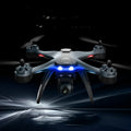 Plastic quadrocopter remote control drone with GPS, camera, and spare blades on landing gear