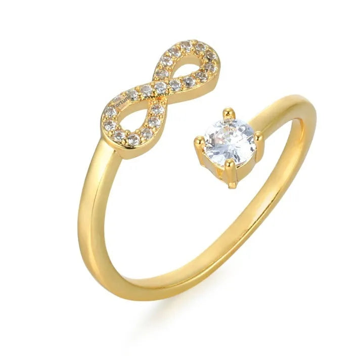 Geometric metal ring with zircon-inlaid initial letter charm in gold, rose gold, or silver.