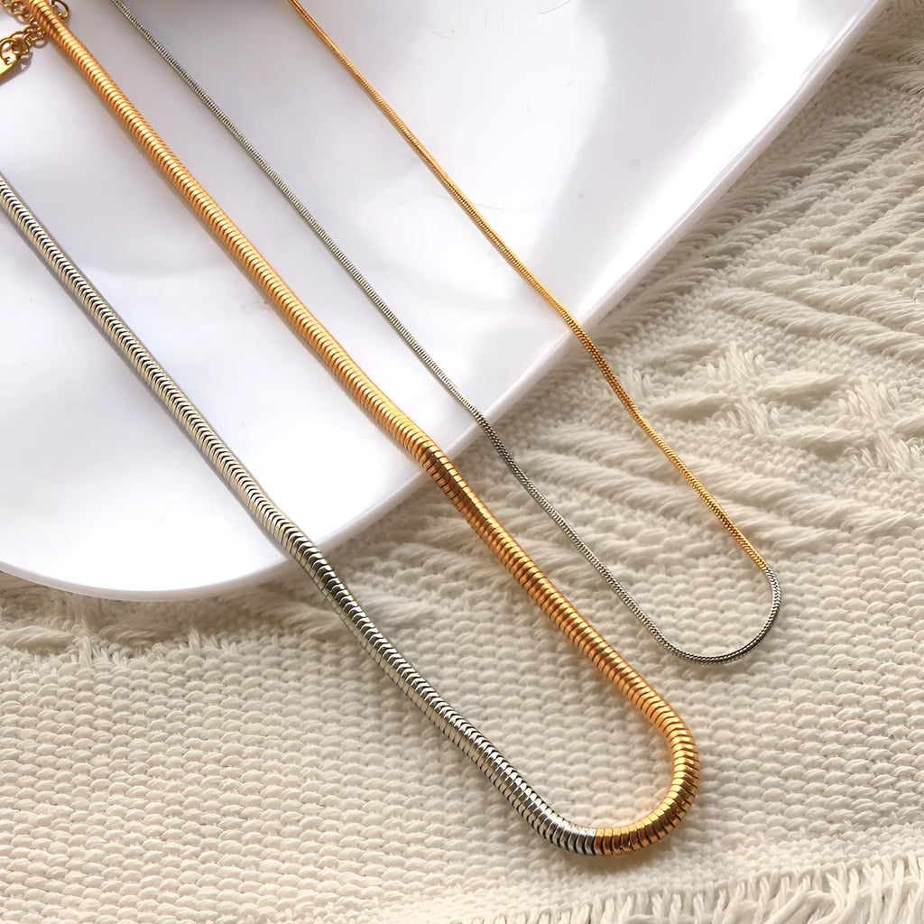 Gold-toned women's snake bones chain necklace with 3mm thick geometric links.