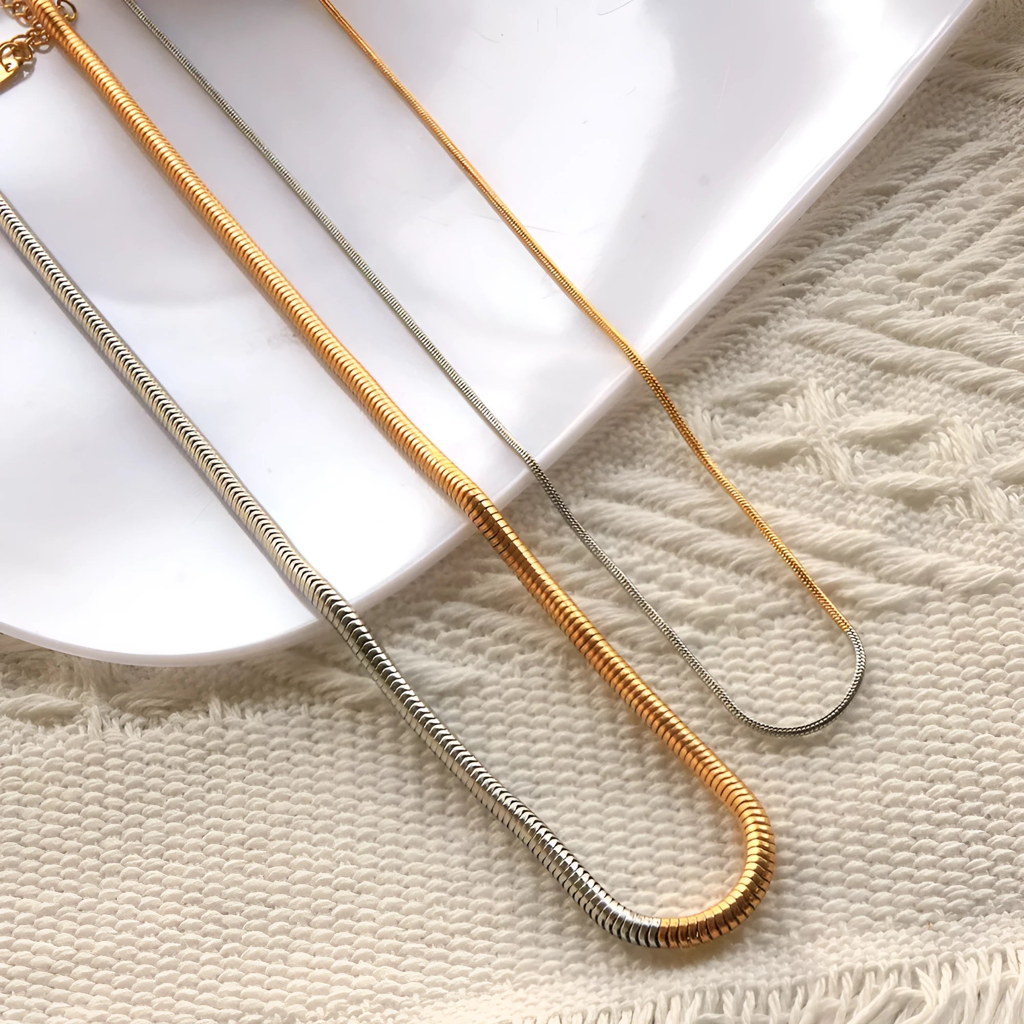 Gold-toned women's snake bones chain necklace with 3mm thick geometric links.