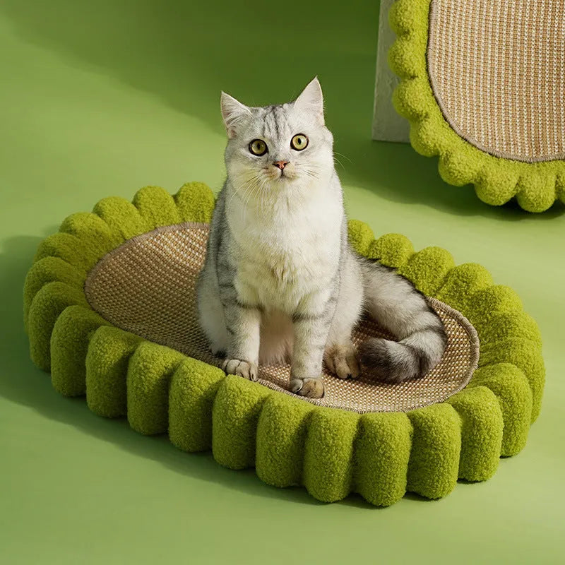 Green oval-shaped cat scratcher pad made of sisal, functioning as both a scratching surface and a lounge bed for cats.