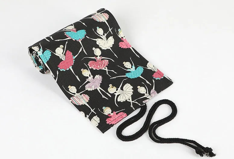 Rolled-up canvas pencil case with ballet girl print, showing multiple pencil slots.