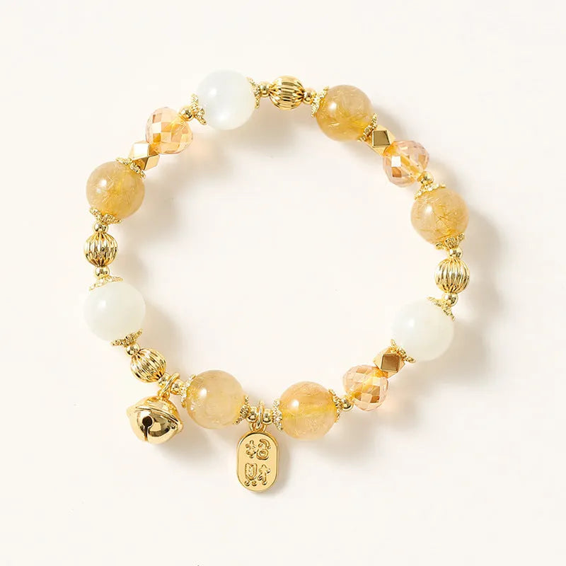Gold coloured rutilated quartz bracelet with Korean style design on wrist