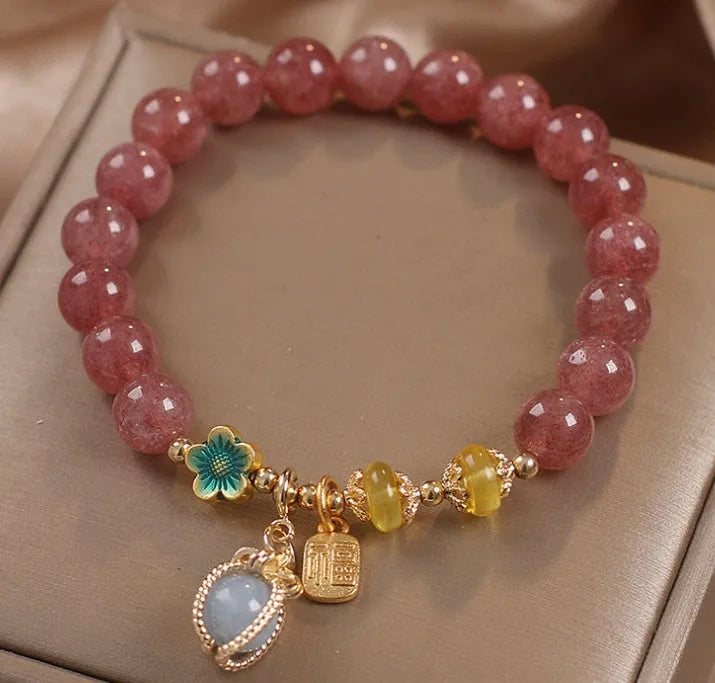 Red women's beaded bracelet with natural strawberry quartz stones, alloy metal, and rhinestone details.
