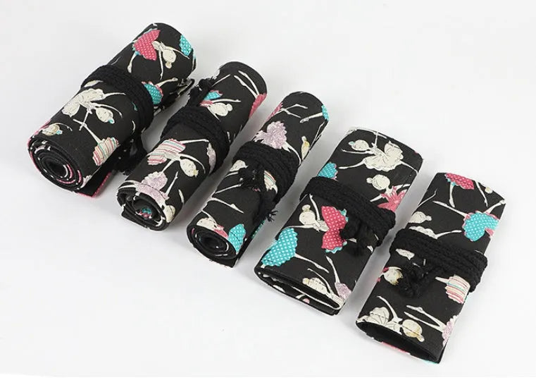 Rolled-up canvas pencil case with ballet girl print, showing multiple pencil slots.