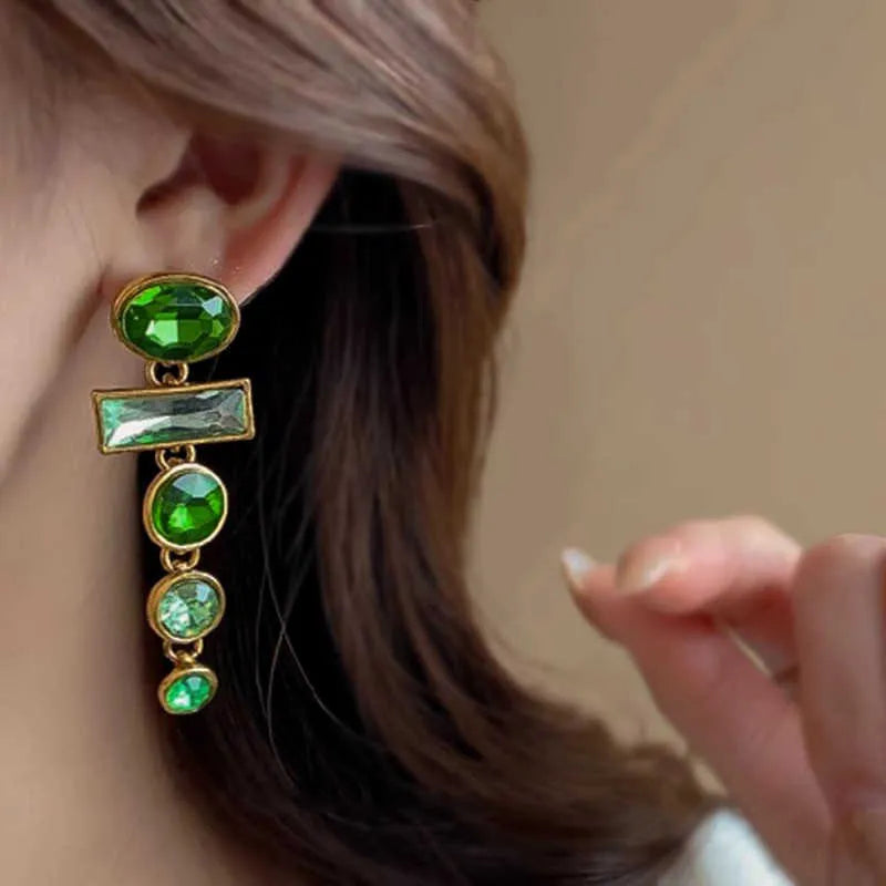 A pair of green gradient geometric alloy earrings with tassels and a zircon stone, shown on a white background.