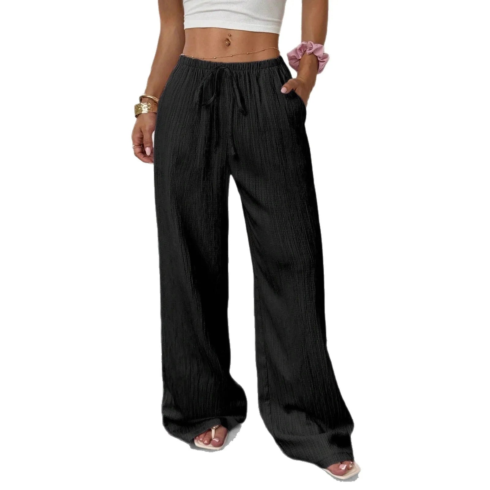 Women's black wide-leg trousers with lace-up waist detail and flowy silhouette
