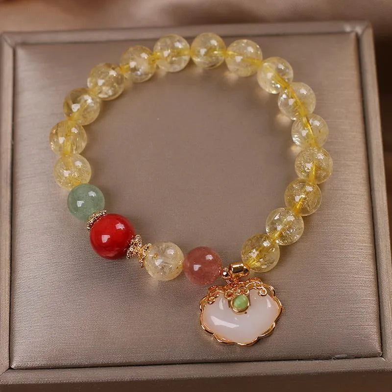 Women's bracelet with a yellow citrine jade ruyi pendant on an alloy chain.