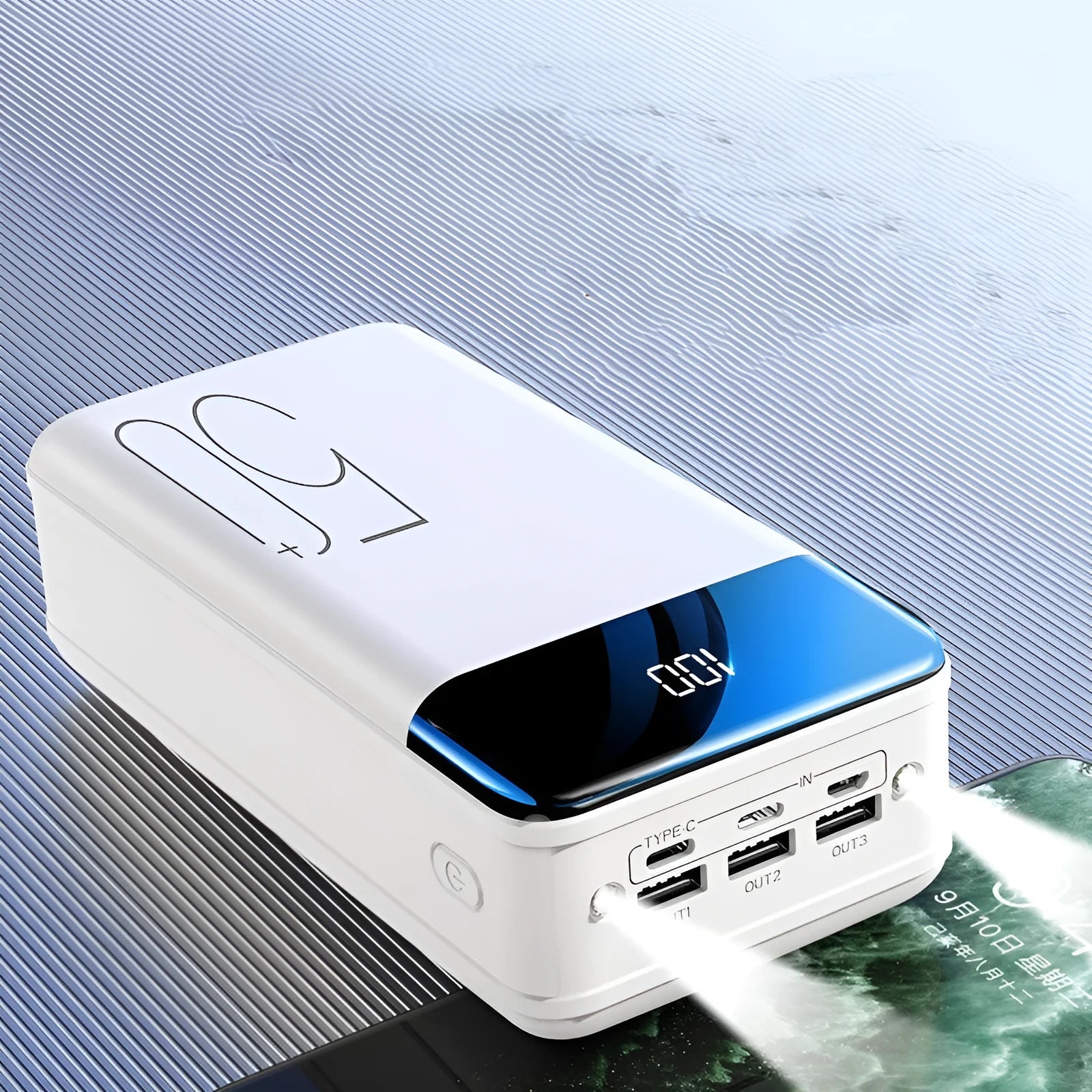 Black and white large 50000mAh power bank with three USB ports showing size scale