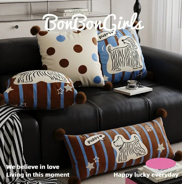 Blue cartoon animal print decorative pillow on a grey sofa.