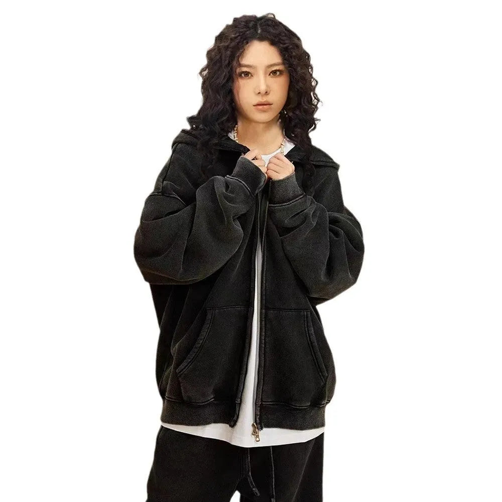 Man wearing a washed black fleece-lined hooded cardigan with a double zipper