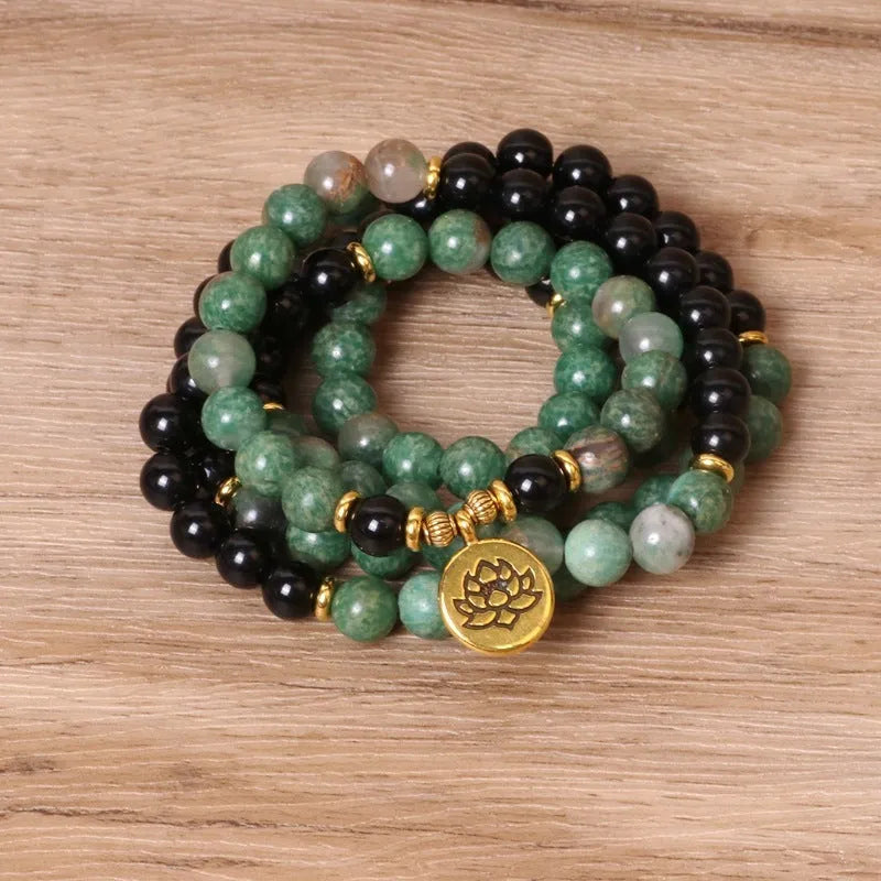 Green and black alloy beads on a stretch elastic bracelet band.