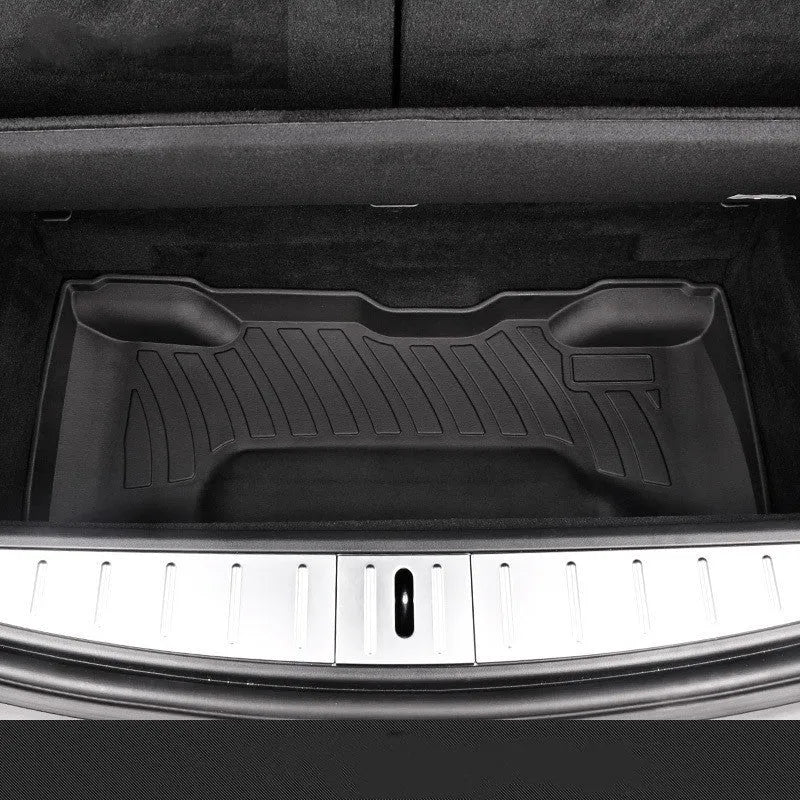 Black rubber floor mat for Tesla car interior with textured TPE footrest section.