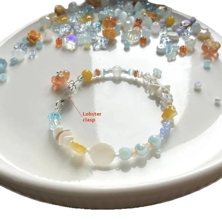 Orange alloy bracelet with diamond shape and round decorative elements on wrist