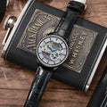 Men's luxury zircon mechanical watch on leather strap showing onion crown and transparent case back.