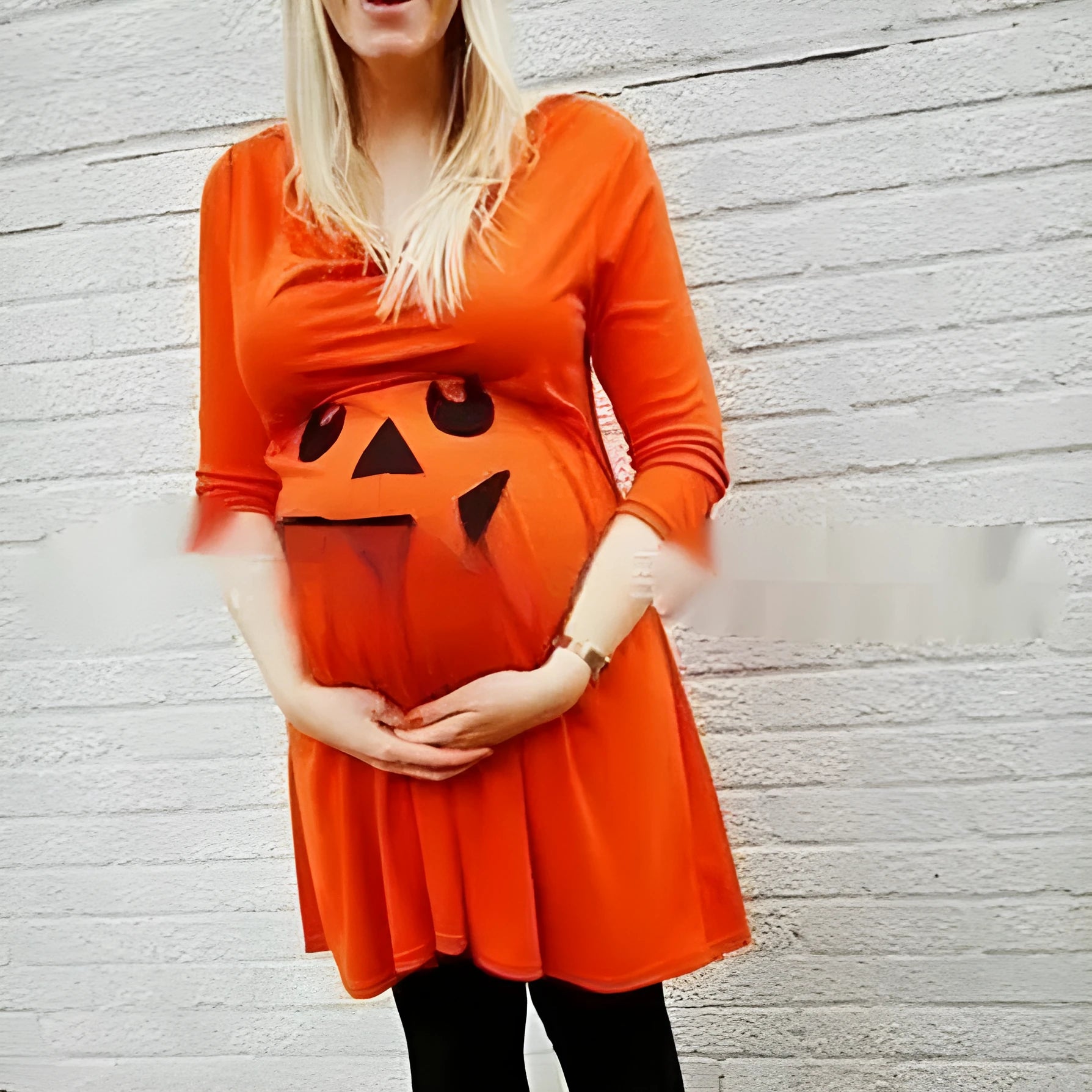 Orange cotton maternity dress with V-neck and long sleeves on hanger