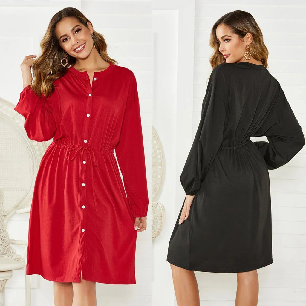 A women's black A-line midi dress with long sleeves, an elastic waist, and an included waist-cinching belt.
