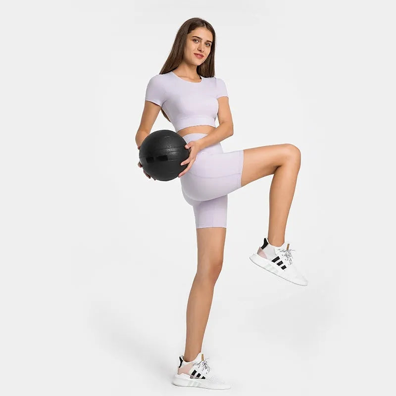 Women's solid colour mid-length sports shorts with super stretch cotton blend fabric.