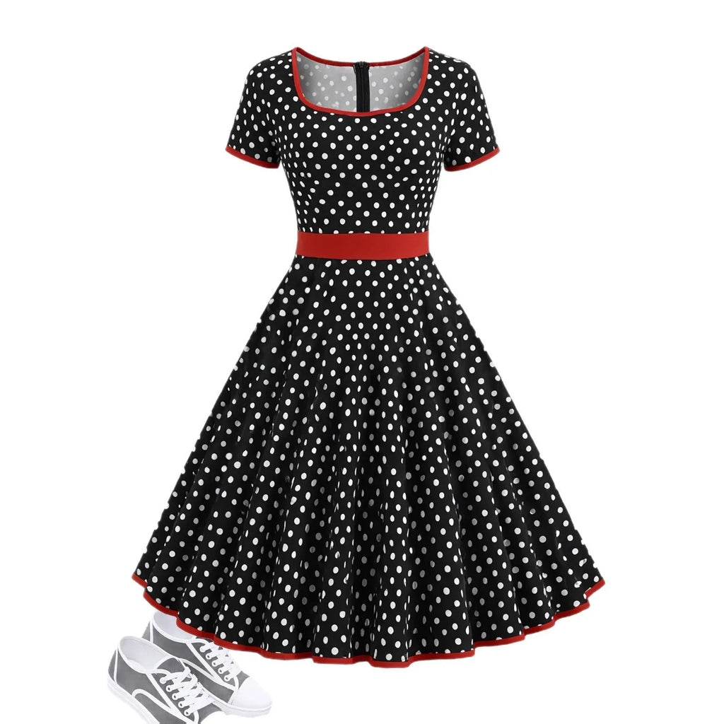 Square collar short sleeve polka dot dress with pleats and a zip on a mid-length skirt.