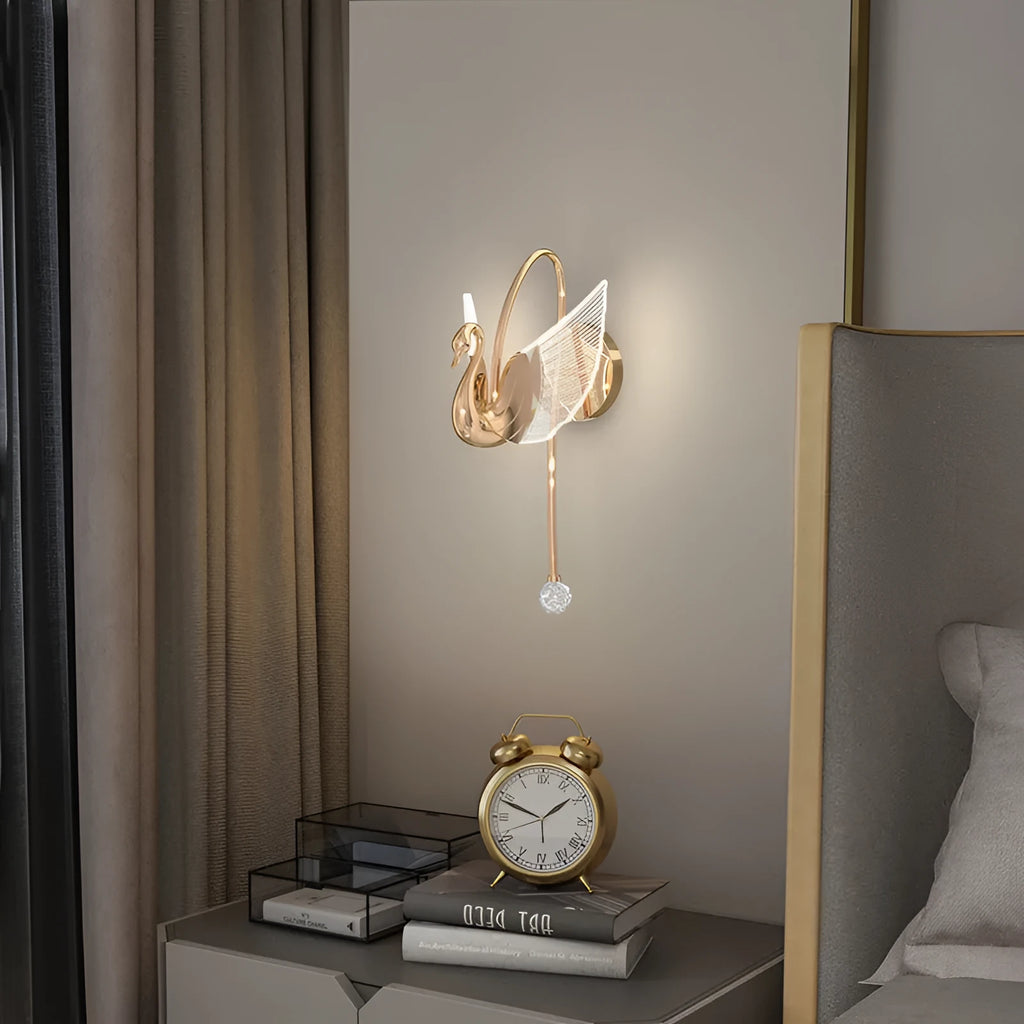 Gold minimalist swan-shaped wall lamp with acrylic shade and dimmable LED light.