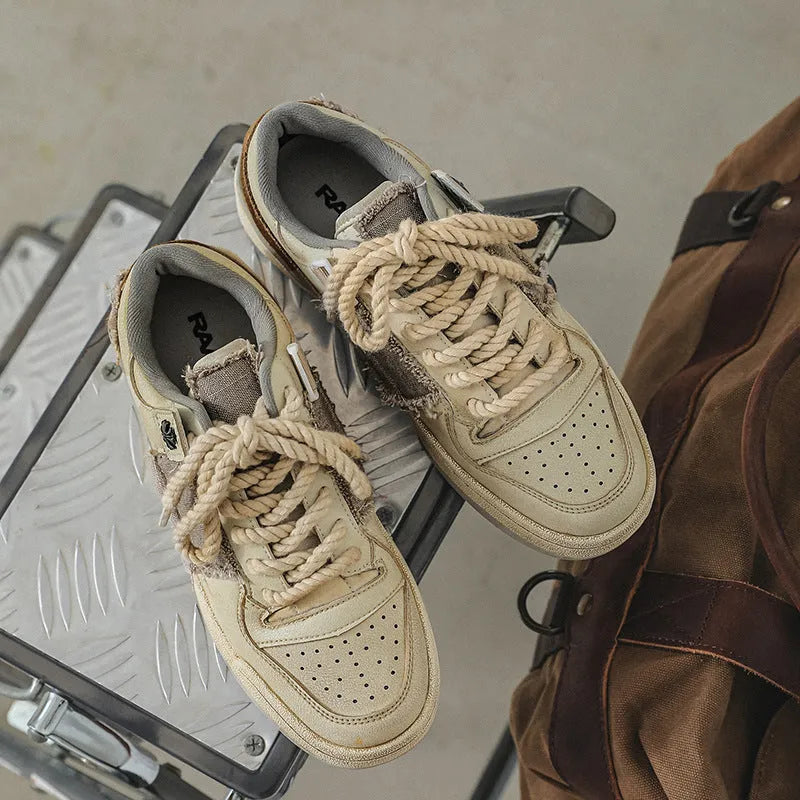 Beige vintage skateboard shoes with patch design, low-top cut, and round toe
