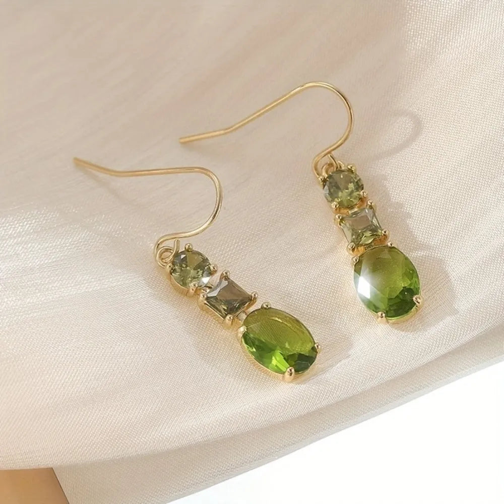 A pair of green geometric quadrilateral earrings made from copper, showing a simple retro bohemian style.