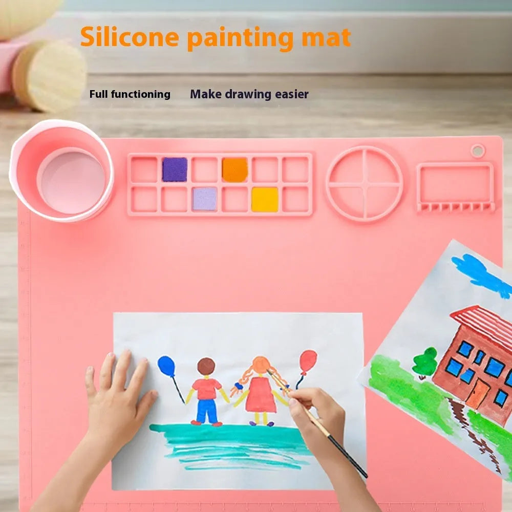 Light blue silicone painting mat with two round mixing bowls on 40x50cm surface