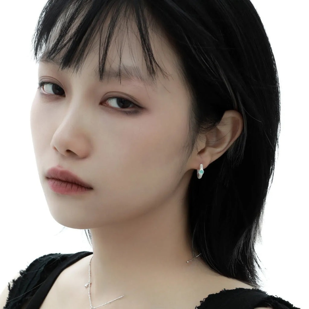 925 sterling silver geometric ear clip with burnt silver electroplated finish and round design elements.