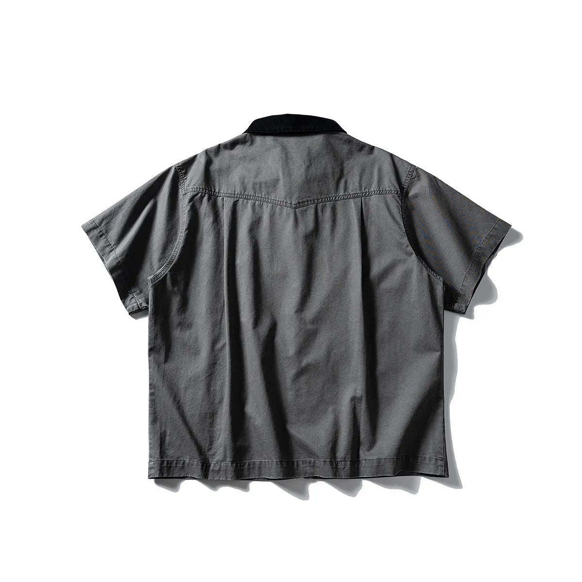 Teenager wearing a khaki loose-fit short sleeve cotton overalls shirt cardigan.