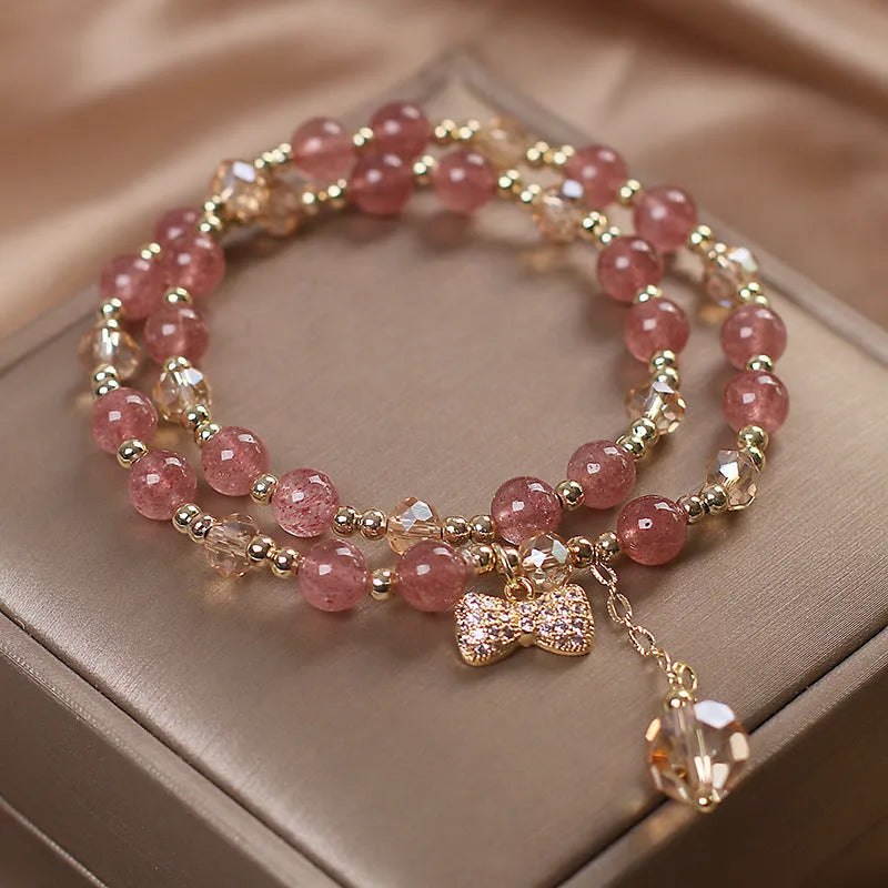 Women's double layer crystal bracelet with lucky cat charm and red cat's eye flowers.